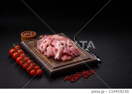 Slices of raw pork or turkey meat with salt, spices and herbs Slices of raw pork or turkey meat with salt, spices and herbs 114459230