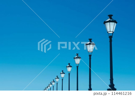 Row of Street Lamps Against a Clear Blue Sky. Generative ai 114461216