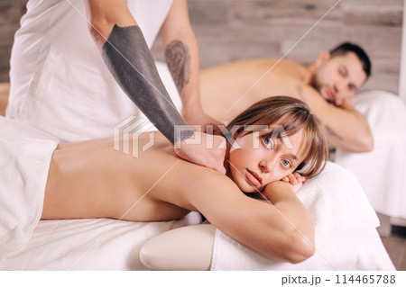 serious blond woman looking at the camera while getting massage serious blond woman looking at the camera while getting massage 114465788