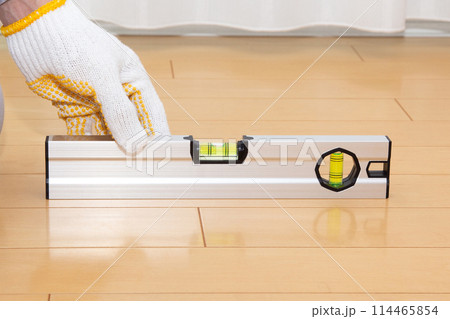 水平器(水準器、レベル)を使って床の水平を調べる業者 水平器(水準器、レベル)を使って床の水平を調べる業者 114465854