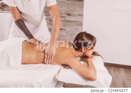 doctor giving a back massage for a female 114465877
