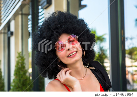 Portrait of a multiethnic woman with black hair wearing red clothes Portrait of a multiethnic woman with black hair wearing red clothes 114465984