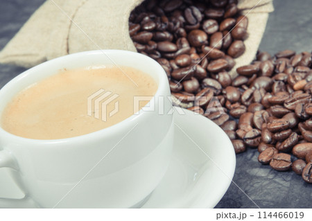 Coffee in cup and roasted dark coffee beans in bag 114466019