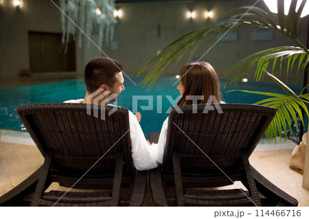 two young people spending their time by the swimming pool two young people spending their time by the swimming pool 114466716