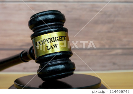 Copyright Law text engraved on lawyer's gavel. Legal and law concept. Copyright Law text engraved on lawyer's gavel. Legal and law concept. 114466745