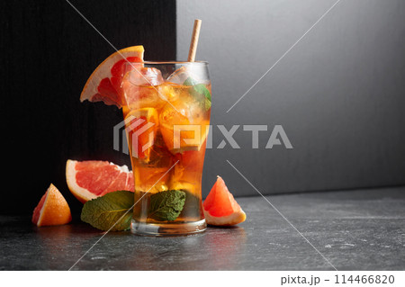 Iced tea or a summer refreshing drink with ice, mint, and grapefruit. 114466820