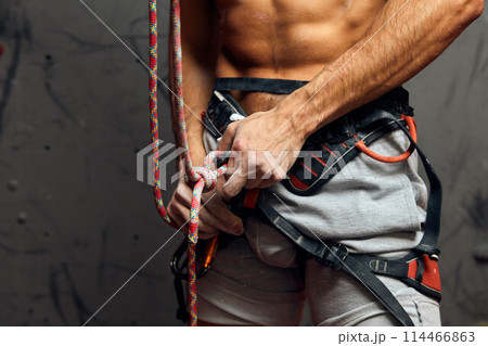 Climber s male hands with equipment during preparation for climb, close-up. Climber s male hands with equipment during preparation for climb, close-up. 114466863