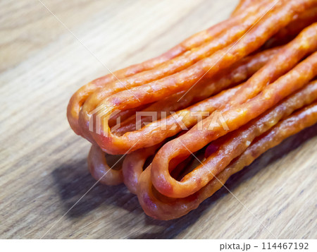 The image could be used in a cookbook, highlighting the main ingredient of a dish. The sausages appearance suggests they are a central part of a hearty meal. 114467192