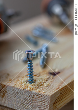 a partially twisted confirmation into a freshly drilled hole in the board 114468185