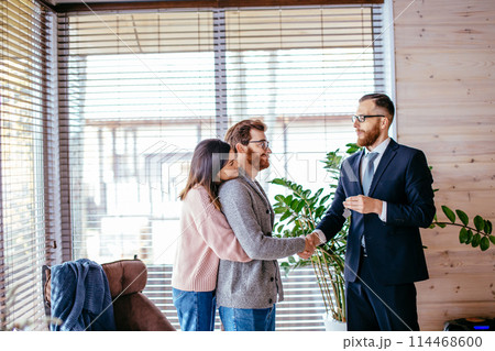 Couple customers signing papers with mortgage broker making purchase deal Couple customers signing papers with mortgage broker making purchase deal 114468600