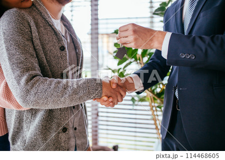 Couple customers signing papers with mortgage broker making purchase deal Couple customers signing papers with mortgage broker making purchase deal 114468605