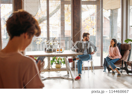 Young couple spending morning in new home, discussing their plans for future Young couple spending morning in new home, discussing their plans for future 114468667