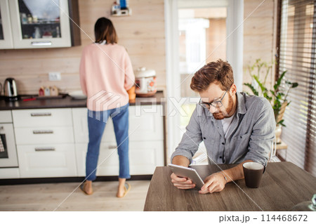 Young couple spending morning in new home, discussing their plans for future 114468672