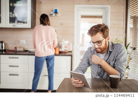 Young couple spending morning in new home, discussing their plans for future. 114469411