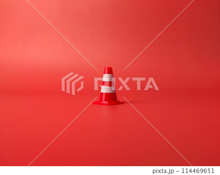 Closeup traffic cones roadblock mini traffic signs on a red background 114469651