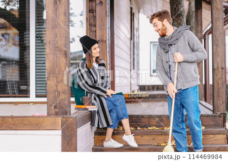 Couple enjoying fall and leisure time outdoors in the private house backyard Couple enjoying fall and leisure time outdoors in the private house backyard 114469984
