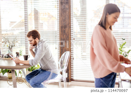 Young couple spending morning in new home, discussing their plans for future. 114470097