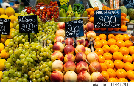 Green grape, mandarins, nectarines for sale. Fresh and organic vegetables and fruits at farmers market. Bunch of bio vegetables sold on market stall. Agriculture and harvesting, food concept Green grape, mandarins, nectarines for sale. Fresh and organic vegetables and fruits at farmers market. Bunch of bio vegetables sold on market stall. Agriculture and harvesting, food concept 114472933