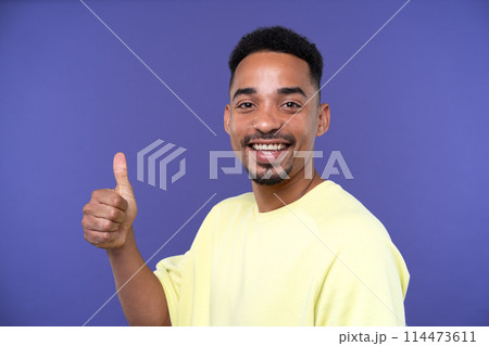 Emotional young black guy in casual raising fists up studio background, celebrating success, happy handsome african american millennial man sharing good emotions, copy space Emotional young black guy in casual raising fists up studio background, celebrating success, happy handsome african american millennial man sharing good emotions, copy space 114473611