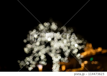 Decorative outdoor string lights at night time, Defocused Background, night city life backdrop, party time with Yellow bokeh balls 114473623