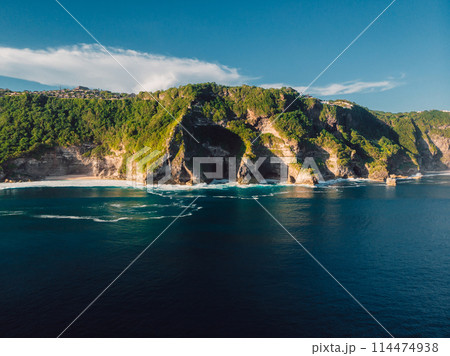 Panoramic landscape with coastline and ocean with waves in Indonesia. Aerial view. Panoramic landscape with coastline and ocean with waves in Indonesia. Aerial view. 114474938