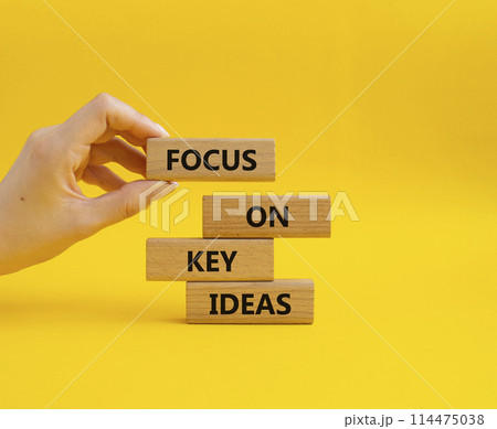 Focus on Key Ideas symbol. Concept words Focus on Key Ideas on wooden blocks. Beautiful yellow background. Businessman hand. Business and Focus on Key Ideas concept. Copy space Focus on Key Ideas symbol. Concept words Focus on Key Ideas on wooden blocks. Beautiful yellow background. Businessman hand. Business and Focus on Key Ideas concept. Copy space 114475038