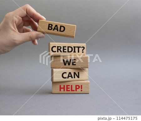 Bad credit We can Help symbol. Wooden blocks with words Bad credit We can Help. Beautiful grey background. Businessman hand. Business and Bad credit We can Help concept. Copy space. 114475175