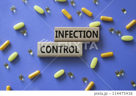 Infection Control symbol. Concept word. Infection Control on wooden blocks. Beautiful purple background with pills. Medicine and Infection Control concept. Copy space Infection Control symbol. Concept word. Infection Control on wooden blocks. Beautiful purple background with pills. Medicine and Infection Control concept. Copy space 114475416