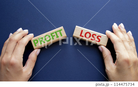 Profit or Loss symbol. Concept word Profit or Loss on wooden blocks. Businessman hand. Beautiful deep blue background. Business and Profit or Loss concept. Copy space Profit or Loss symbol. Concept word Profit or Loss on wooden blocks. Businessman hand. Beautiful deep blue background. Business and Profit or Loss concept. Copy space 114475734