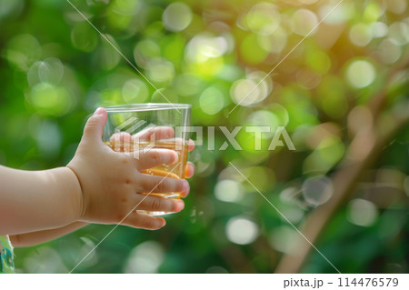 Cute child holds glass of water 114476579