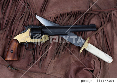 Old West Revolver with bowie knife on leather jacket 114477304