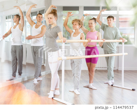 Ballet lesson for teenagers - choreographer teaches girls and boys ballet steps in studio 114479537