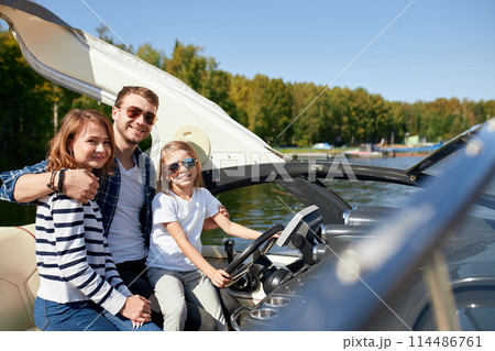 happy family with daughter on sailing boat at sunny autumn day 114486761