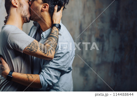 Cay couple enjoy togetherness indoors, kiss each other 114488644