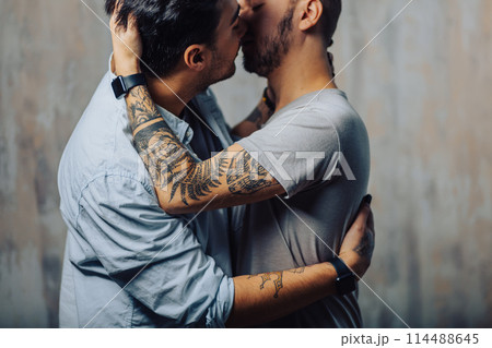 Cay couple enjoy togetherness indoors, kiss each other Cay couple enjoy togetherness indoors, kiss each other 114488645