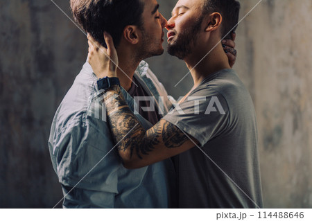 Cay couple enjoy togetherness indoors, kiss each other Cay couple enjoy togetherness indoors, kiss each other 114488646