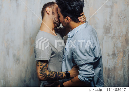 Cay couple enjoy togetherness indoors, kiss each other 114488647
