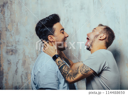 Cay couple enjoy togetherness indoors, kiss each other Cay couple enjoy togetherness indoors, kiss each other 114488650