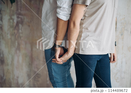 Two upset men standing back to back isolated over white loft background. 114489672