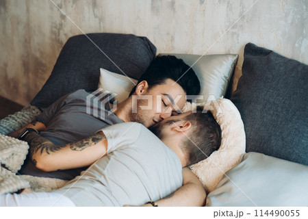A homosexual couple on bed in studio with loft interior A homosexual couple on bed in studio with loft interior 114490055