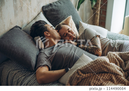A homosexual couple on bed in studio with loft interior A homosexual couple on bed in studio with loft interior 114490084