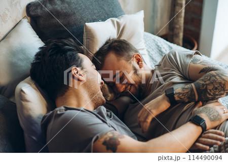 A homosexual couple on bed in studio with loft interior A homosexual couple on bed in studio with loft interior 114490094