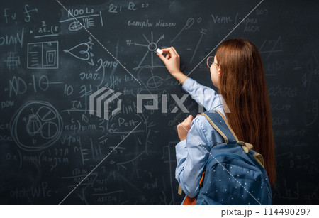 Teenager in class on background of blackboard Teenager in class on background of blackboard 114490297