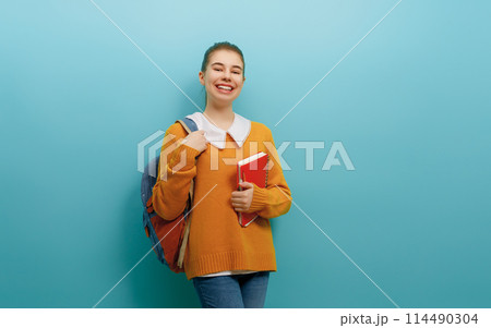 teenager on color paper wall background 114490304