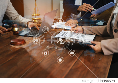 Teamwork of business lawyer meeting working hard about legal legislation in courtroom to help their customer.. 114490574