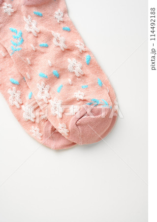 Pink socks with pattern on white background Pink socks with pattern on white background 114492188