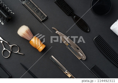 Variety of Hair Styling Tools and Accessories Displayed on a Dark Background Variety of Hair Styling Tools and Accessories Displayed on a Dark Background 114492311