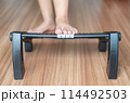 Woman massage with foot rest under desk for relieve plantar fasciitis at home 114492503