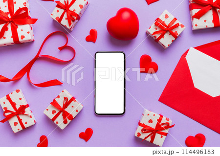 mobile phone with blank screen on colored background with hearts, valentine day concept top view flat lay 114496183