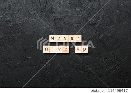 never give up word written on wood block. never give up text on cement table for your desing, concept never give up word written on wood block. never give up text on cement table for your desing, concept 114496417